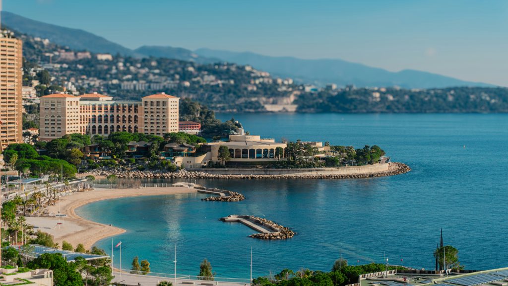 Larvotto public beach in Monaco with clear water and city skyline