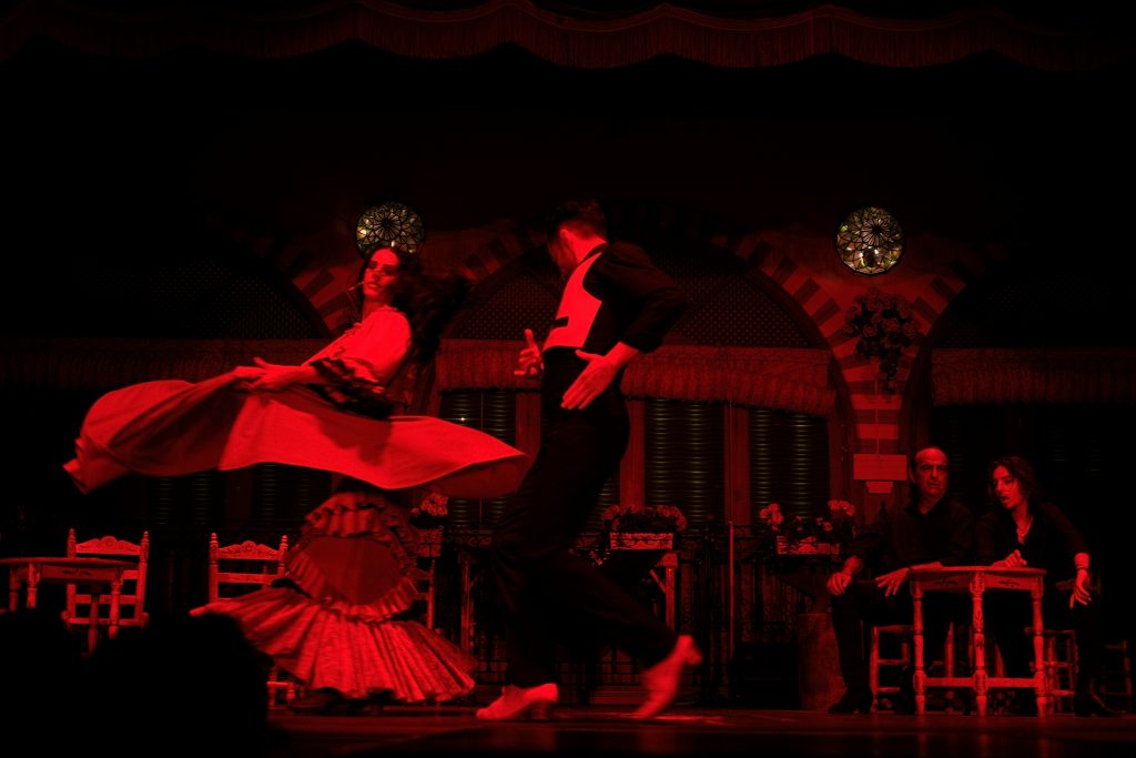 Traditional flamenco dancer performing an emotional dance with dramatic movement and expressive posture