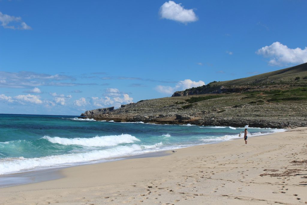 Cala Mesquida beach in Mallorca with sand dunes, open sea, and dramatic coastal landscape