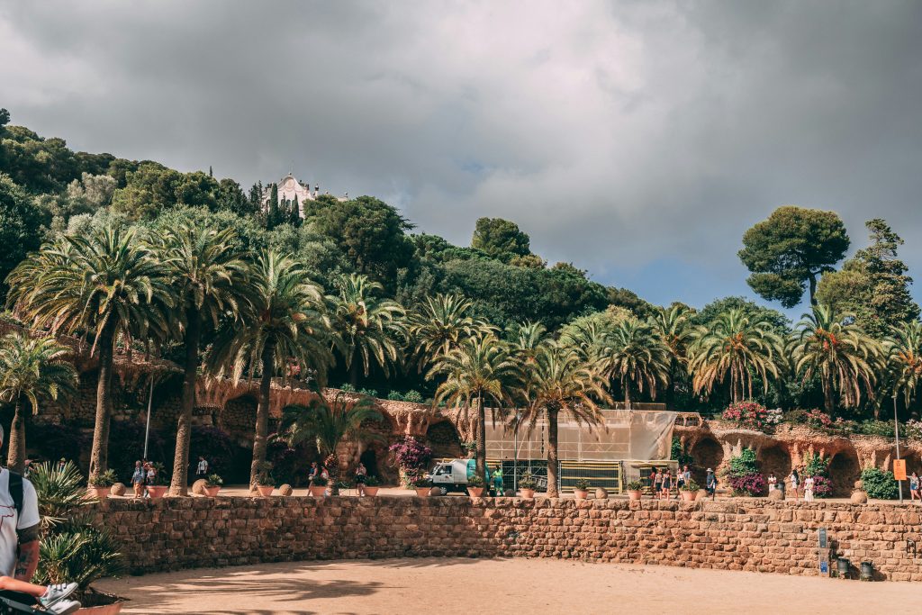 Stone viaduct pathways surrounded by greenery in Park Güell
