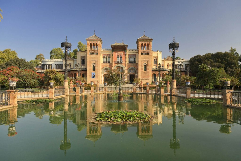 María Luisa Park in Seville with lush gardens, shaded paths, and fountains