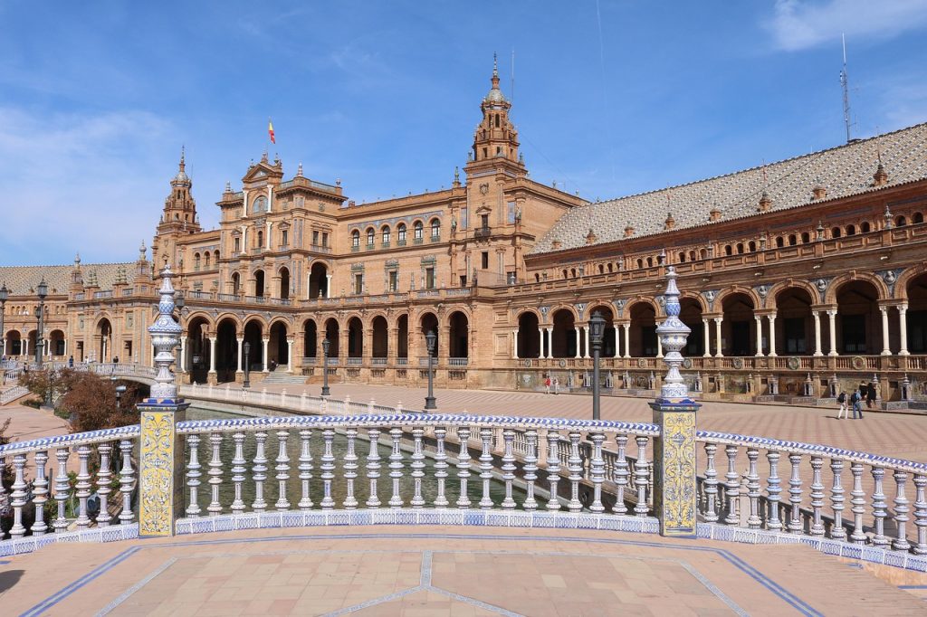 Plaza de España in Seville featuring grand architecture, canal bridges, and tiled benches