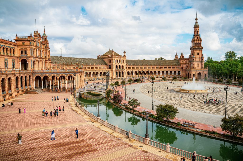 Historic streets of Seville with traditional Andalusian architecture, flamenco culture, and iconic landmarks.