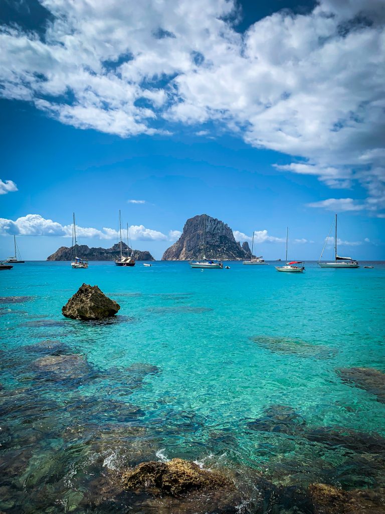 Island landscape of Mallorca and Ibiza showing turquoise waters, rocky coastline, beaches, and Mediterranean scenery.
