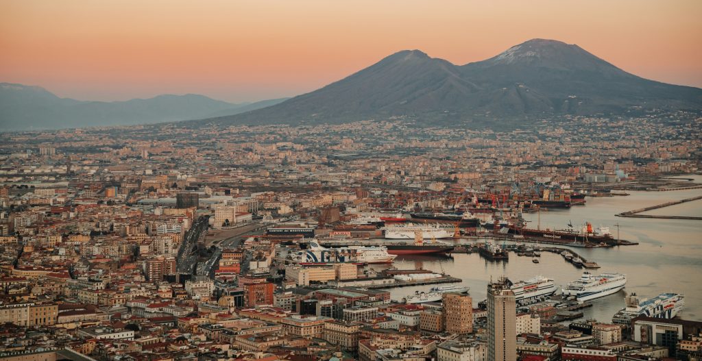 Mount Vesuvius volcano overlooking the Bay of Naples, with hiking trails leading to the crater and panoramic views of the surrounding coastline.