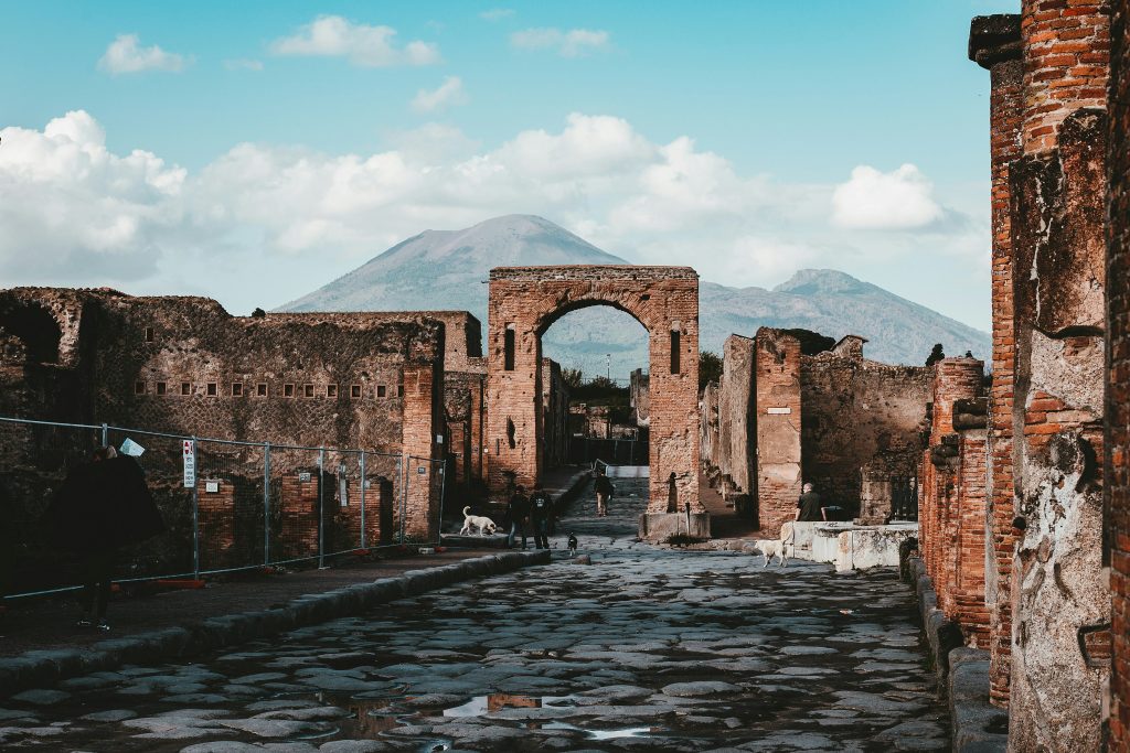 Ancient ruins of Pompeii and Herculaneum preserved by volcanic ash, showing Roman streets, houses, and daily life near Mount Vesuvius.