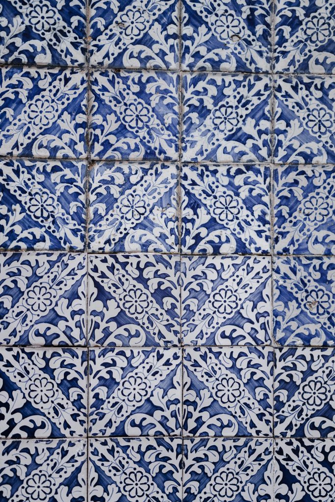 Traditional Portuguese azulejos blue ceramic tiles decorating historic buildings, showcasing intricate patterns that define Portugal’s architectural and cultural identity.
