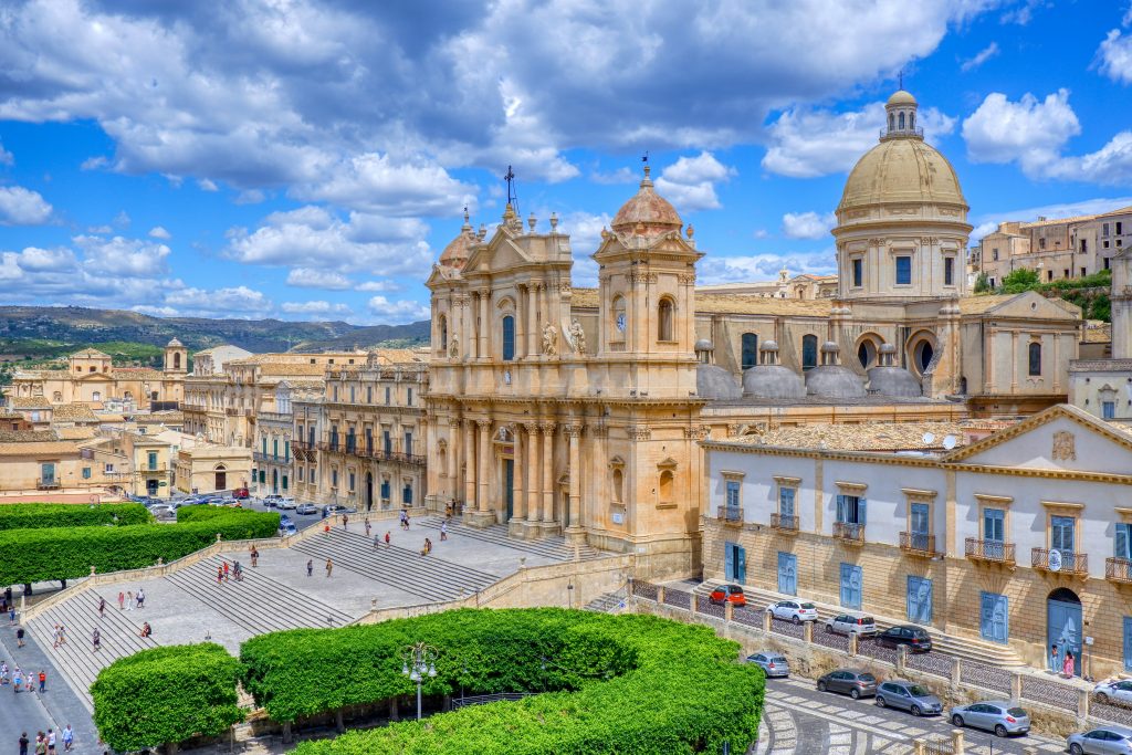 South-east Sicily featuring the UNESCO baroque towns of Noto, Modica, and Ragusa, with ornate limestone architecture, historic streets, sunlit squares, and a calm traditional Sicilian atmosphere ideal for food and culture lovers