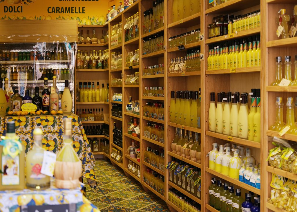 Traditional limoncello liqueur made from Amalfi Coast lemons served in coastal setting