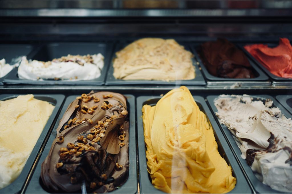 Colorful Italian gelato displayed in a traditional gelateria, showcasing multiple flavors of authentic Italian ice cream