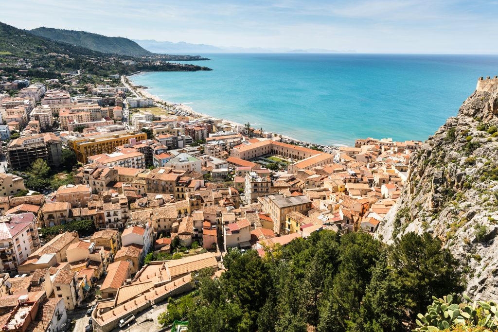 Sicily island landscape with Mount Etna, ancient ruins, and Mediterranean coastline
