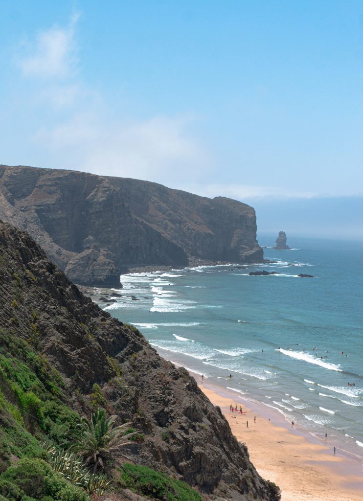 Arrifana beach surrounded by cliffs with strong Atlantic surf and wild coastal scenery