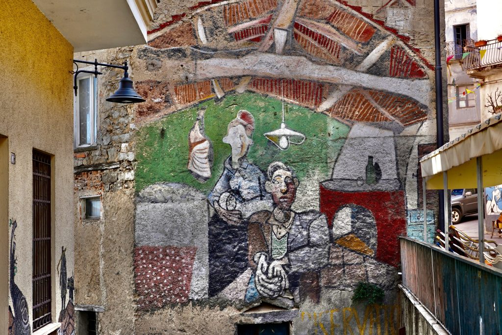 Colorful political and historical murals painted on buildings in Orgosolo village, Sardinia