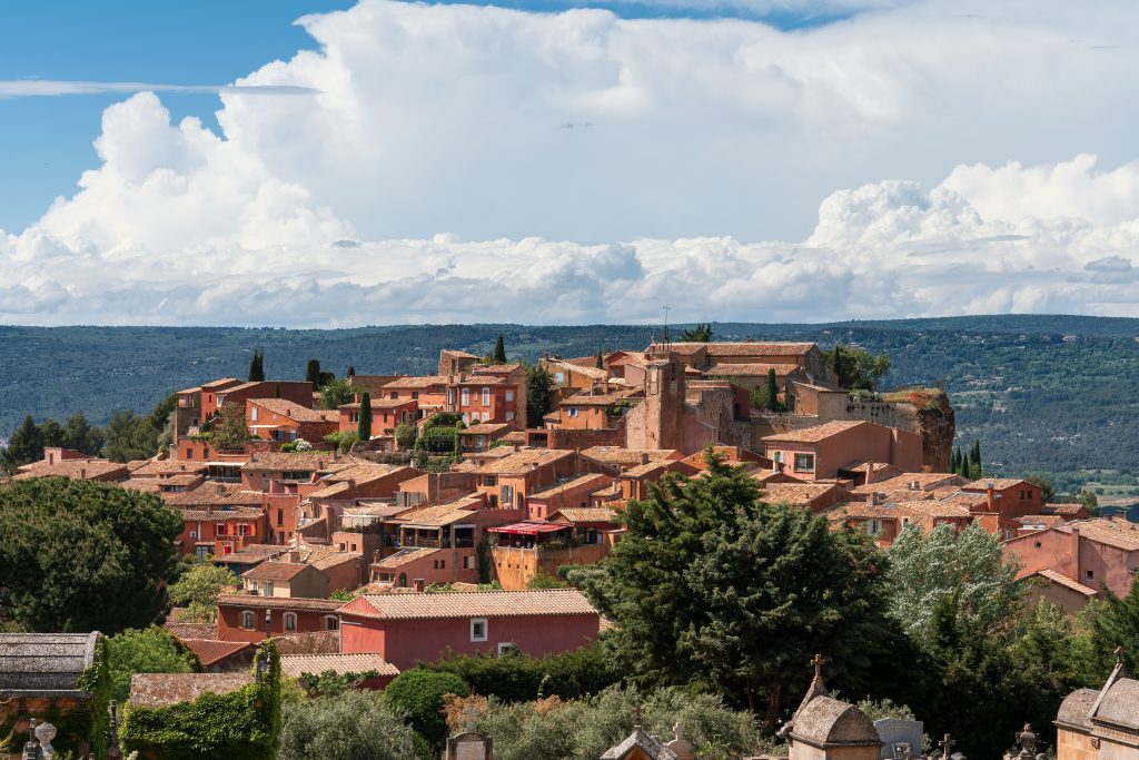 Roussillon village in Provence with red ochre cliffs and colorful landscapes