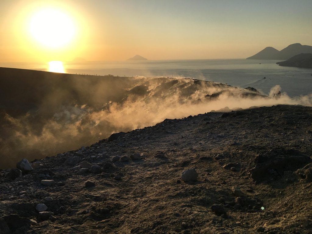 Aeolian Islands in Sicily featuring volcanic landscapes, crystal-clear Mediterranean water, dramatic coastlines, black sand beaches, and island villages under active volcanoes