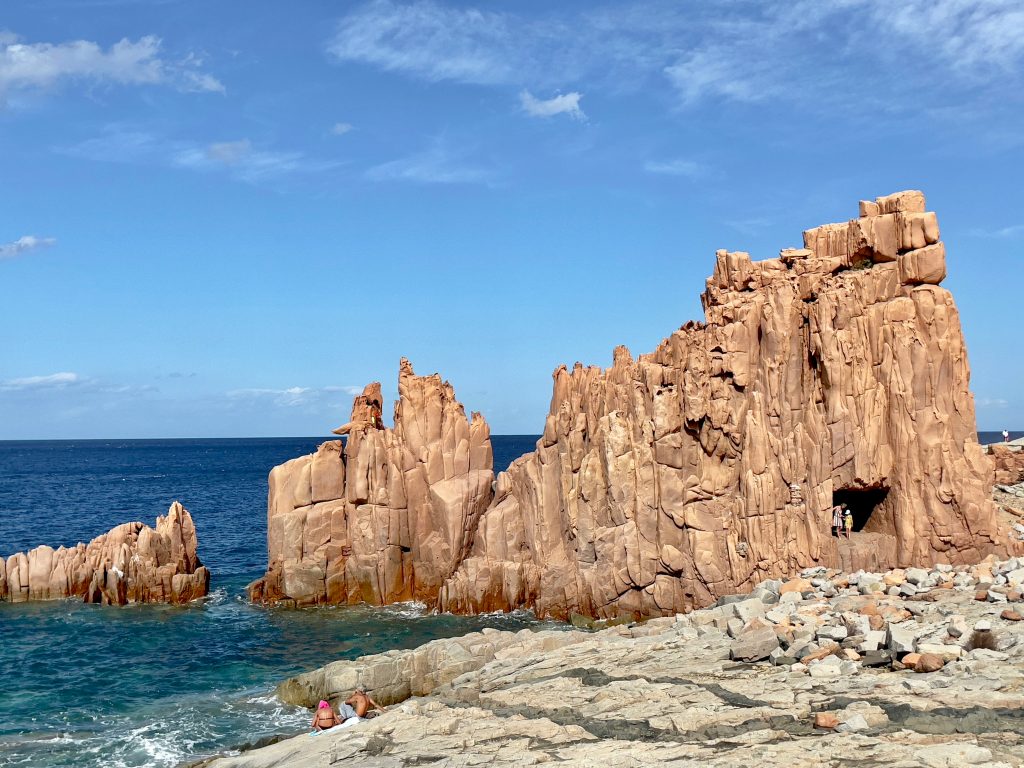Red porphyry rocks rising from the blue Mediterranean Sea at Arbatax on Sardinia’s east coast