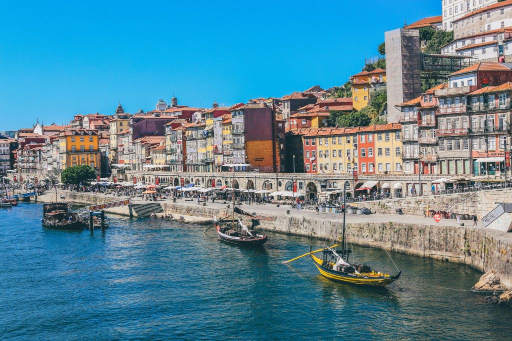 Porto riverfront with colorful houses, Douro River, historic bridges, and traditional Portuguese architecture