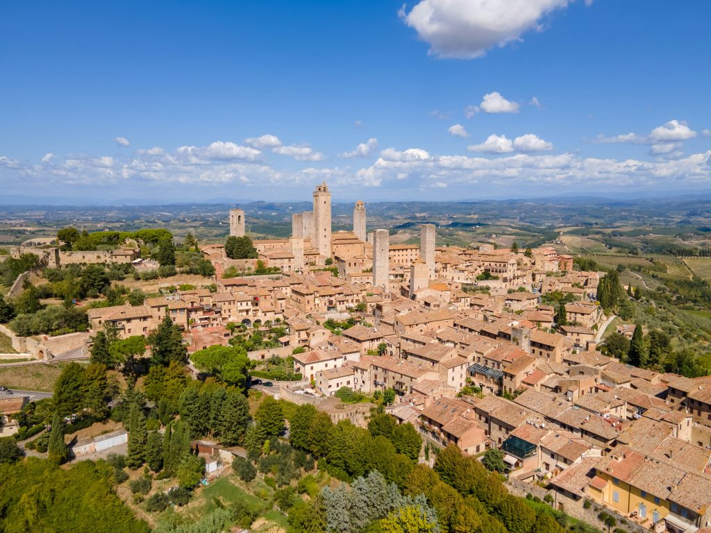 San Gimignano medieval hill town in Tuscany with iconic stone towers rising above the countryside, known as the “Town of Towers” and famous for its historic skyline and world-class gelato.