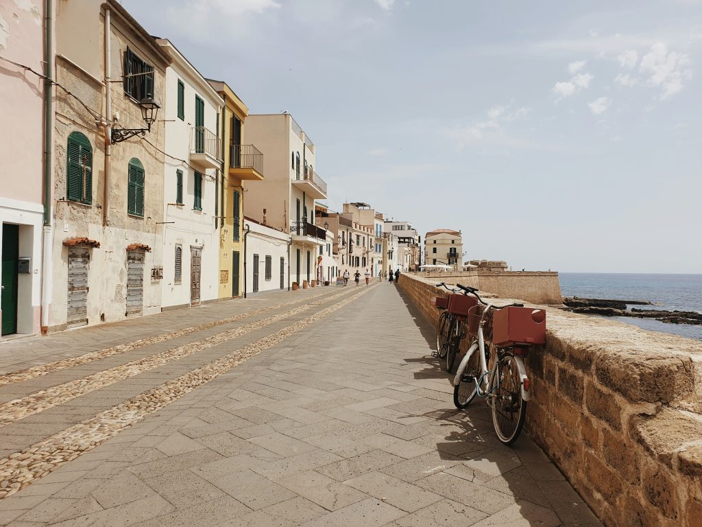 Historic old town of Alghero, Sardinia, known for its Catalan history, ancient sea walls, and authentic Italian street food.