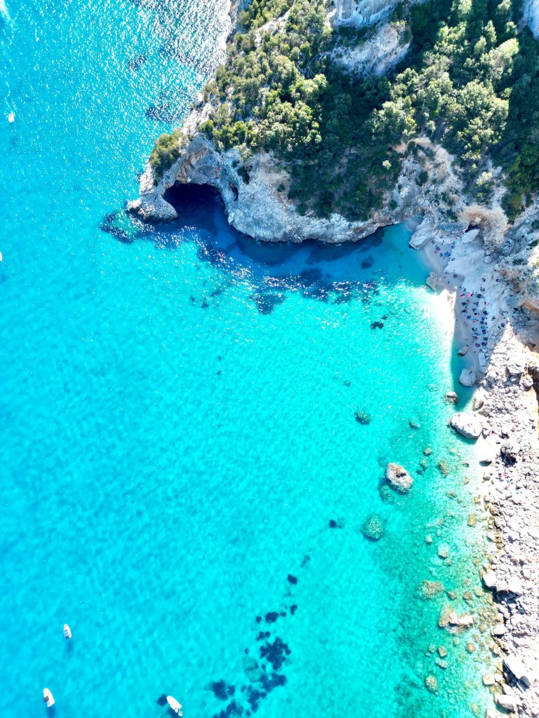 Cala Goloritzé beach in Sardinia with its iconic limestone arch, turquoise water, and protected natural access along the dramatic eastern coastline