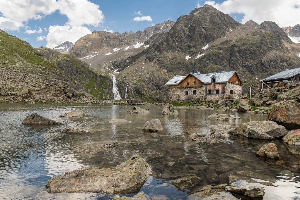 Mountain refuges in the French Alps with hikers and alpine scenery