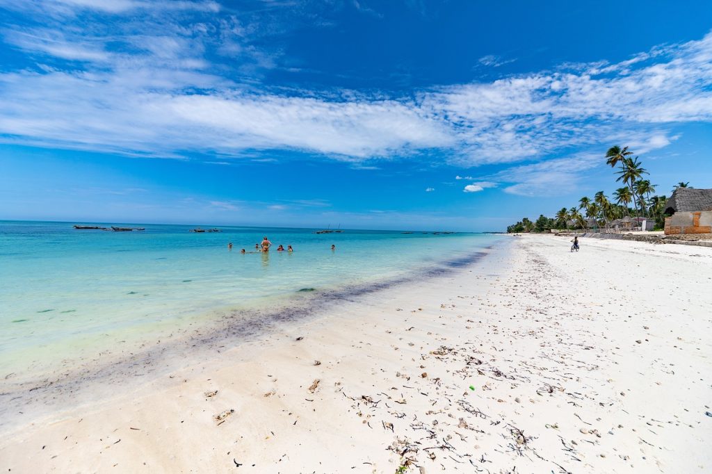 Kendwa Beach Zanzibar with clear blue water, wide white sand beach and sunset coastline views
