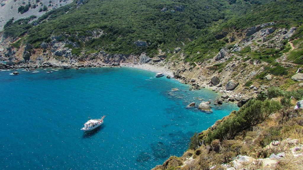 Skiathos island in Greece with pine forests, sandy beaches and turquoise Aegean Sea coastline