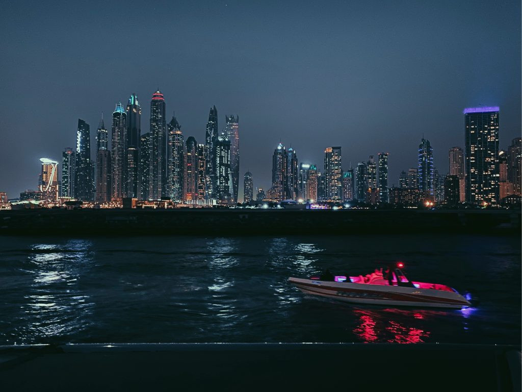 Luxury yacht cruising in Dubai with skyline view and marina in the background