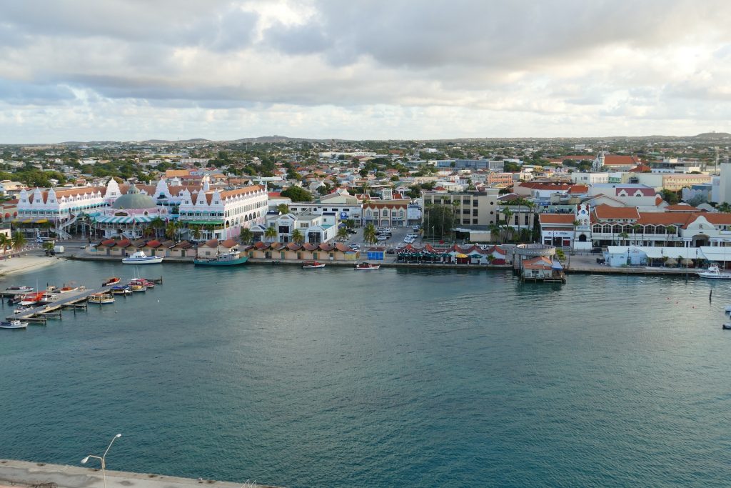 Aruba Travel Guide colorful Dutch Caribbean buildings in Oranjestad capital city with waterfront harbor