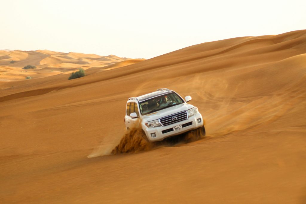 Desert safari in Dubai with dune bashing, camel ride, and sunset in the desert