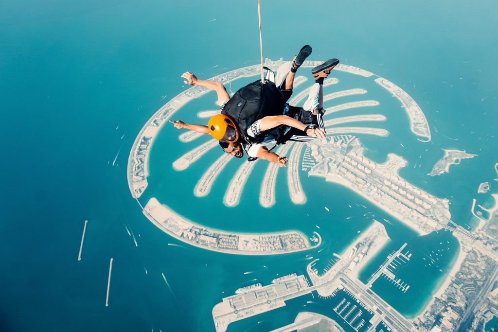 Skydiving over Palm Jumeirah with aerial view of island and coastline