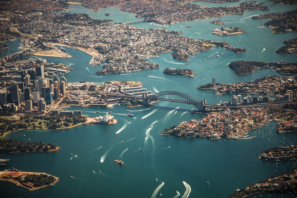 Australia travel guide skyline featuring Sydney Opera House, Harbour Bridge and coastal city views