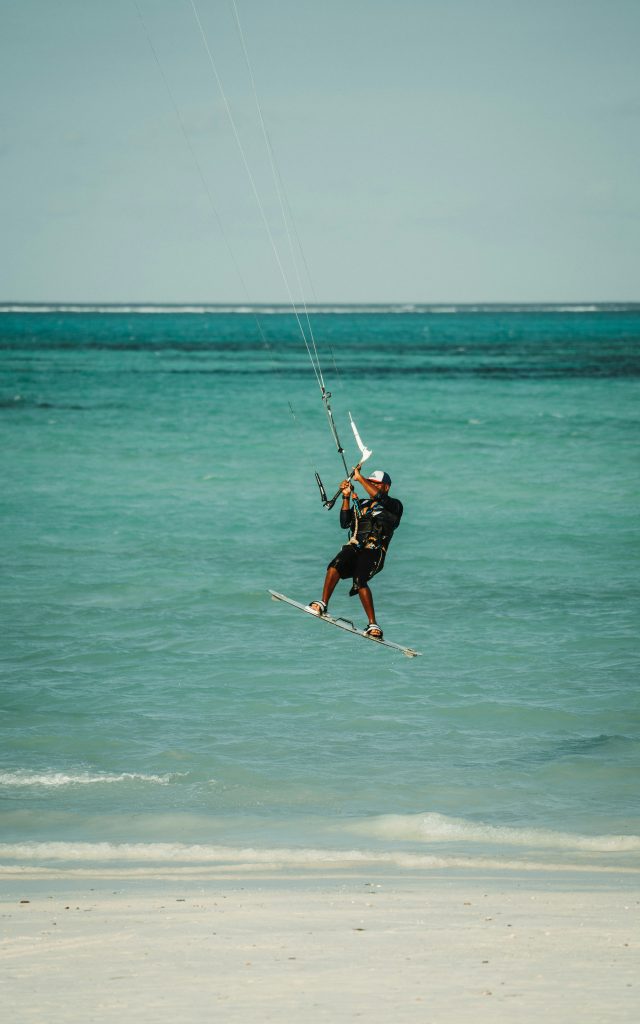 Jambiani Beach Zanzibar with traditional fishing village, white sand and calm tropical ocean water