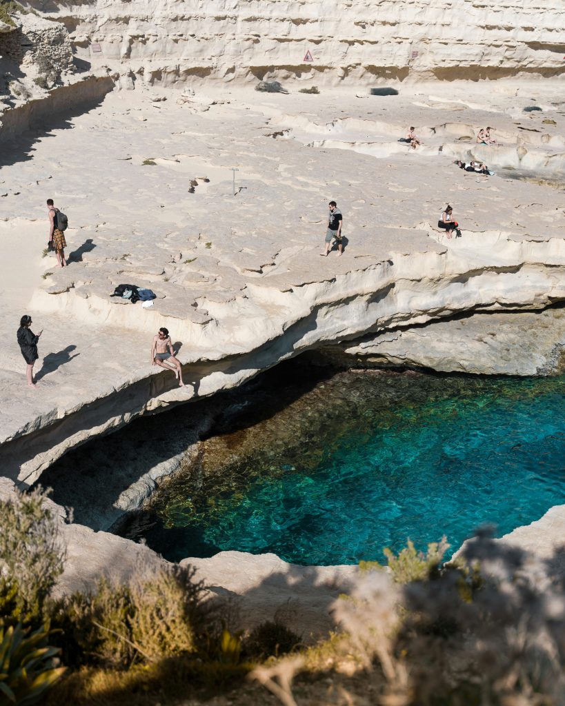 Malta travel guide St Peters Pool natural rock formation crystal clear water swimming spot Malta