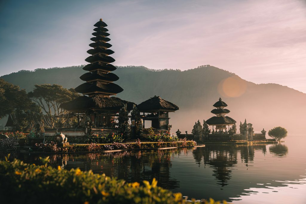 Bali travel guide famous Bali temple on a cliff with ocean views during sunset