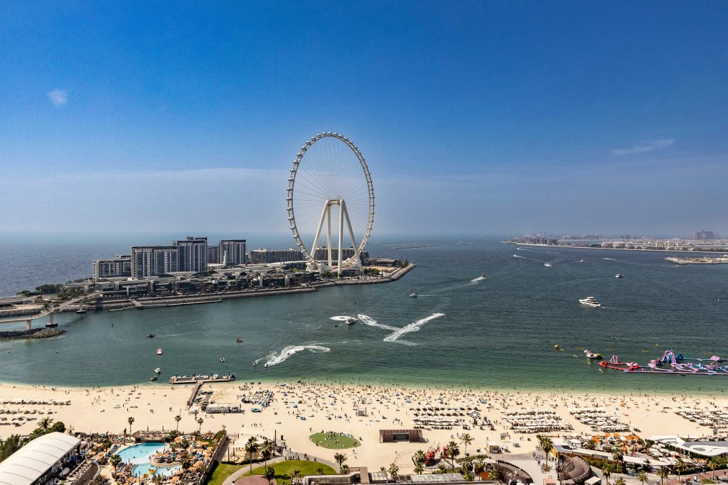 JBR Beach in Dubai with sandy shoreline, clear water, and city skyline