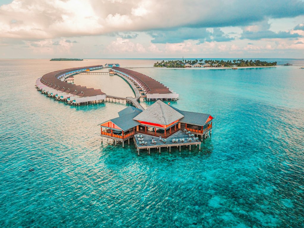 Maldives overwater villas with wooden bungalows above clear turquoise lagoon