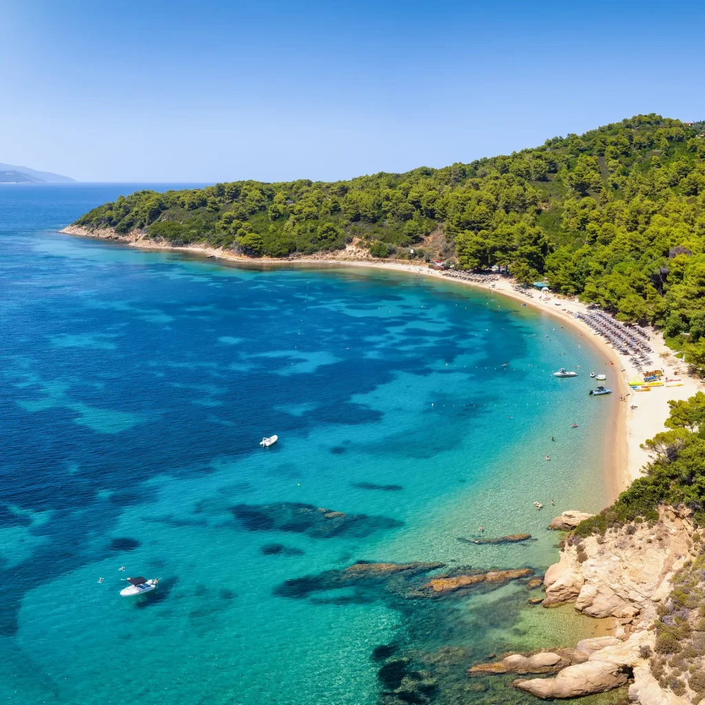 Agia Eleni Beach in Skiathos during sunset with calm sea and west-facing golden horizon