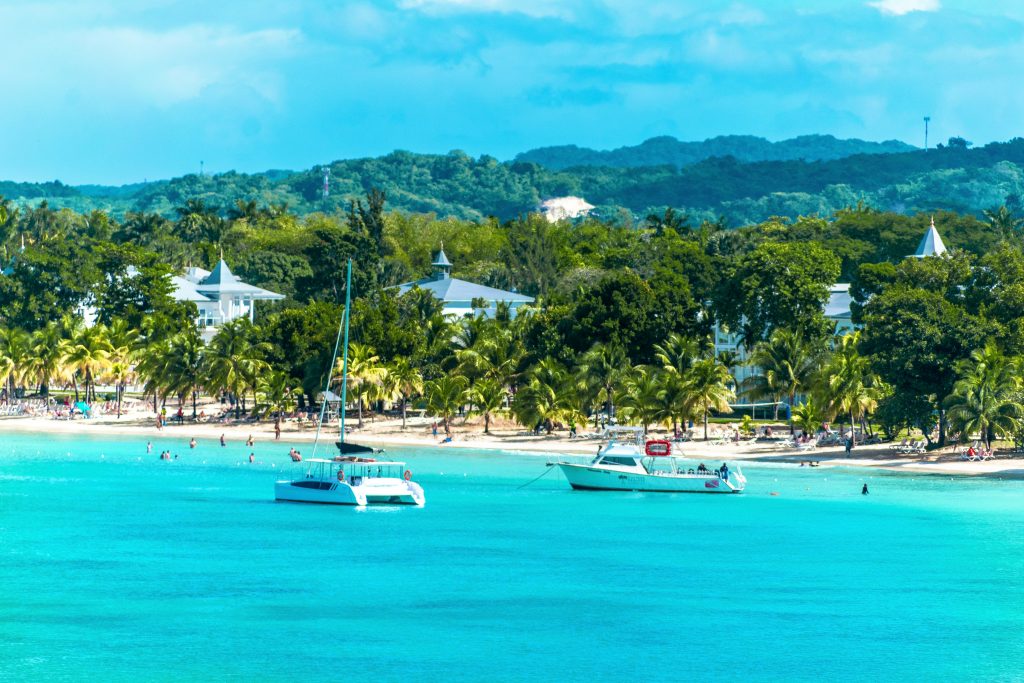 Caribbean Travel Guide Jamaica tropical beach with turquoise water and palm trees