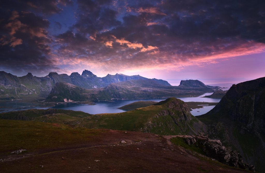 Norway fjords mountain landscape at sunset with dramatic sky and coastal views in Norway