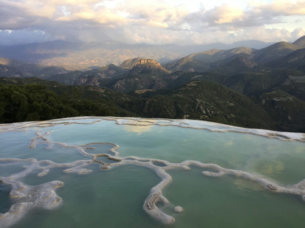 Hierve el Agua natural rock formations in Mexico resembling waterfalls with mountain views