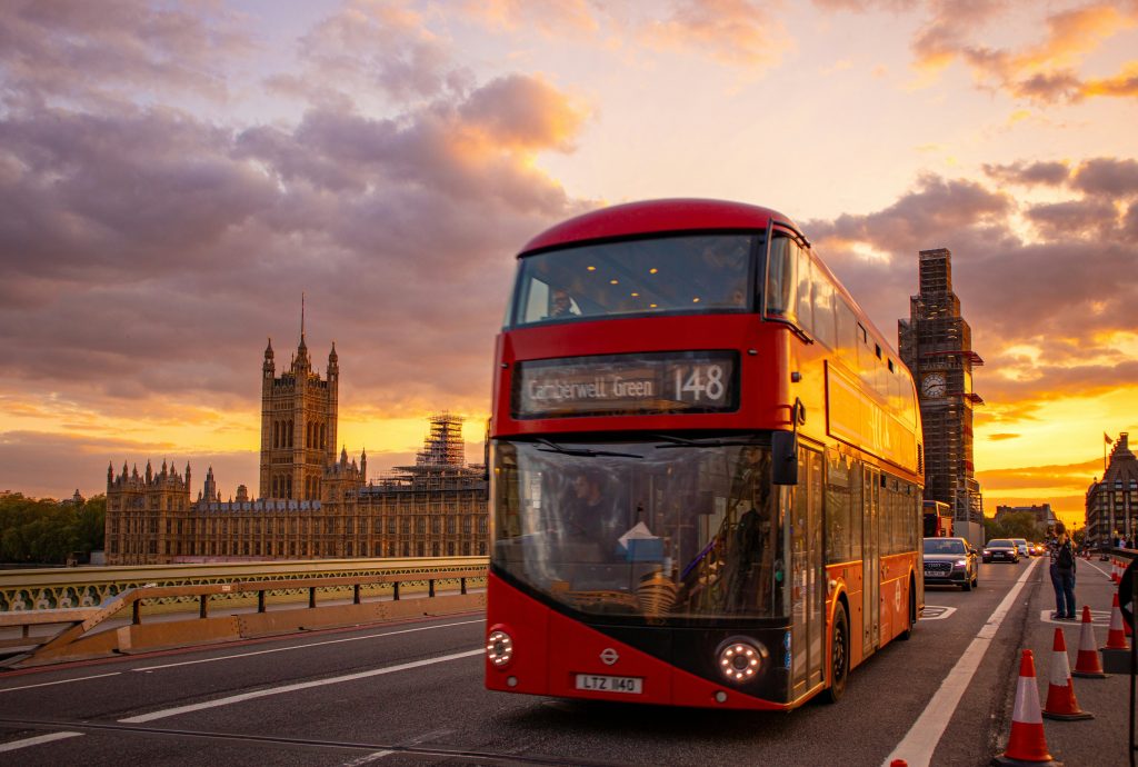 London travel guide red double decker bus on Westminster Bridge with Big Ben view
