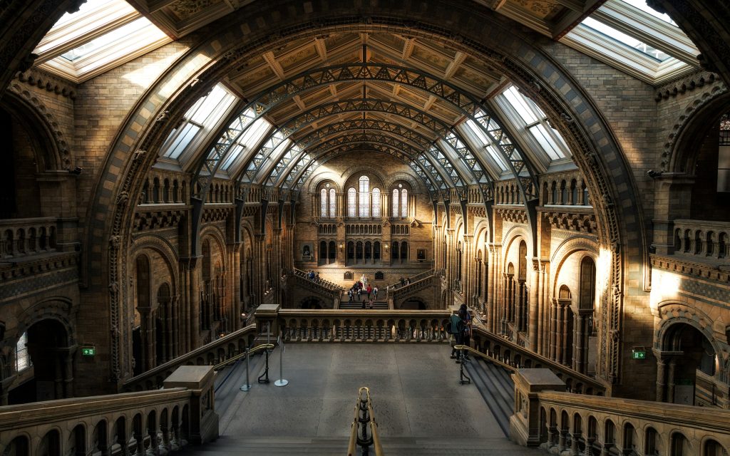 interior of a historic museum in London with large arches and detailed architecture