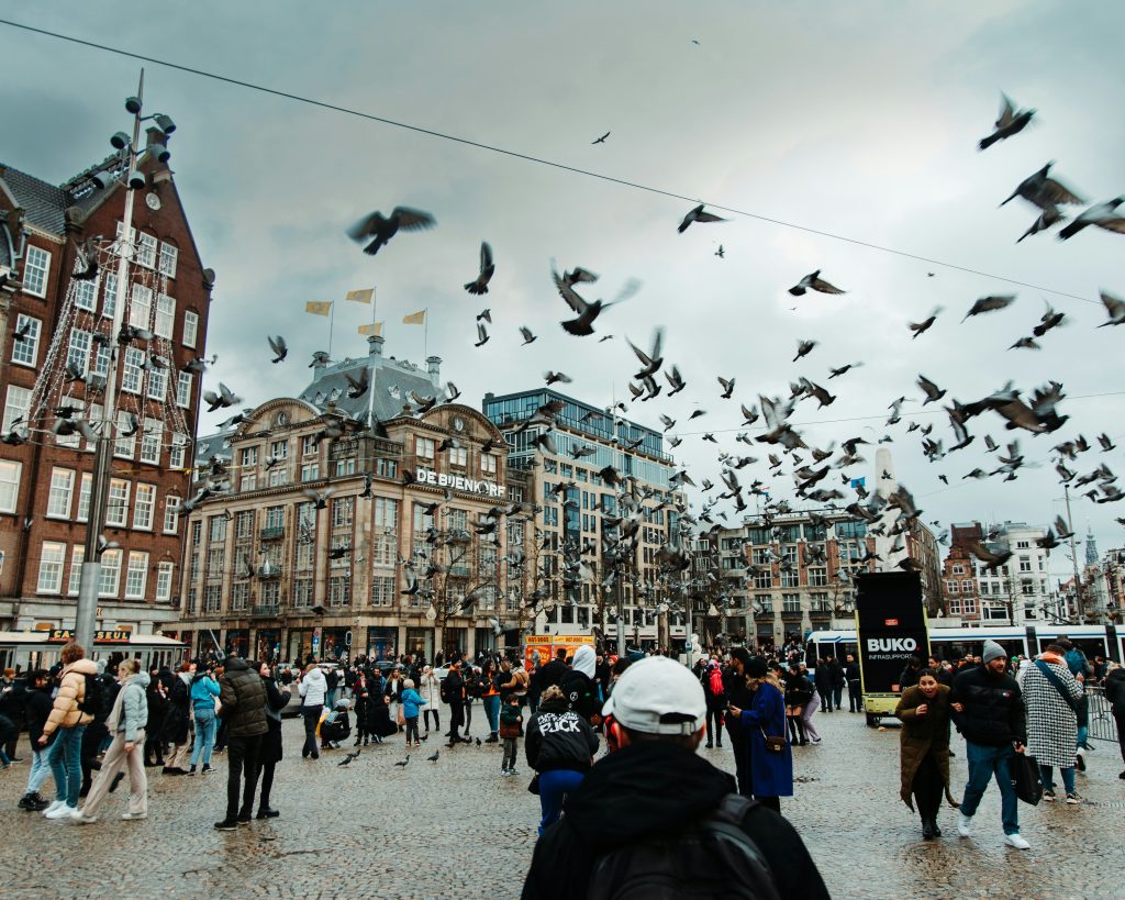 Crowded street in Amsterdam with tourists and city atmosphere