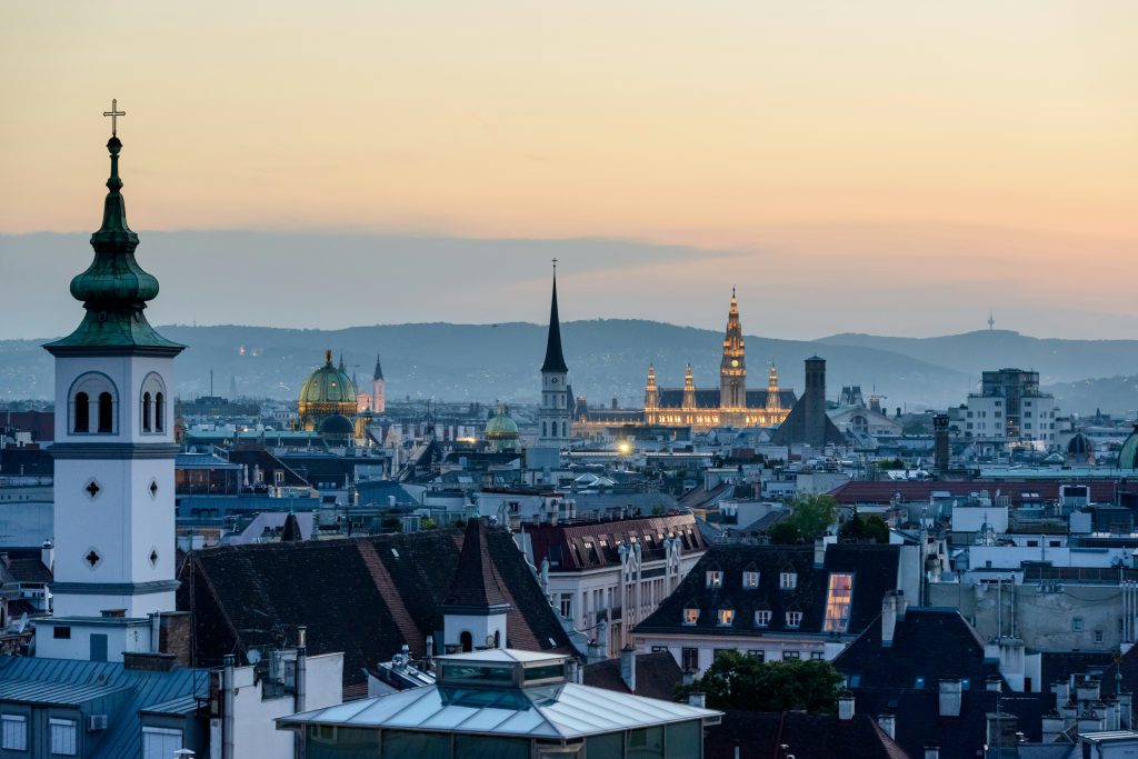 panoramic view of Vienna skyline with rooftops and historic towers at sunset