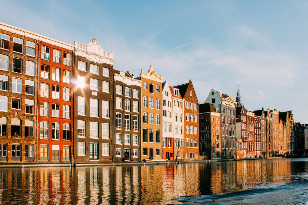 Narrow houses in Amsterdam along the canal with unique architecture