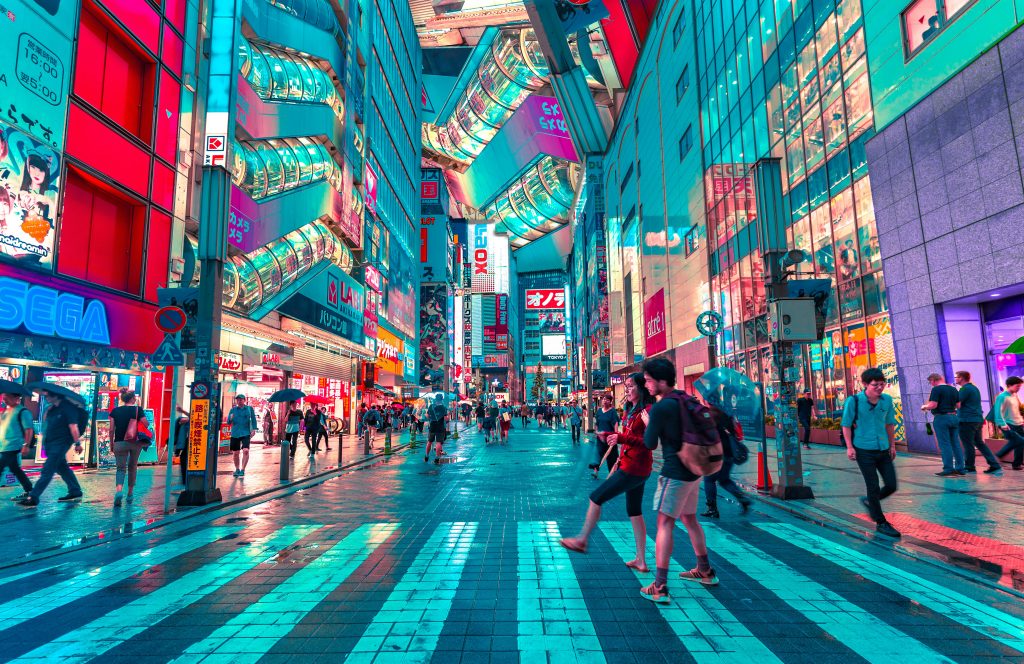 Busy street in Tokyo with neon lights, people walking and urban city life – Tokyo travel guide