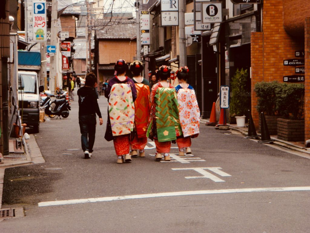 Geisha walking in Kyoto traditional district with historic streets and cultural atmosphere – Kyoto travel guide