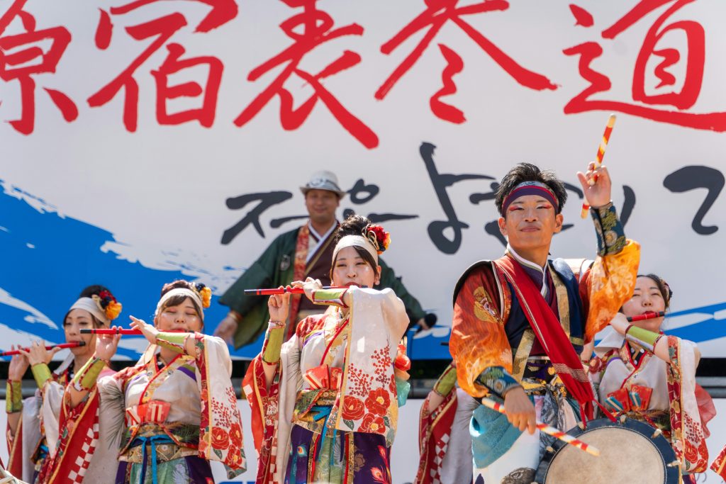Traditional Japanese performance with people in kimono and stage setting