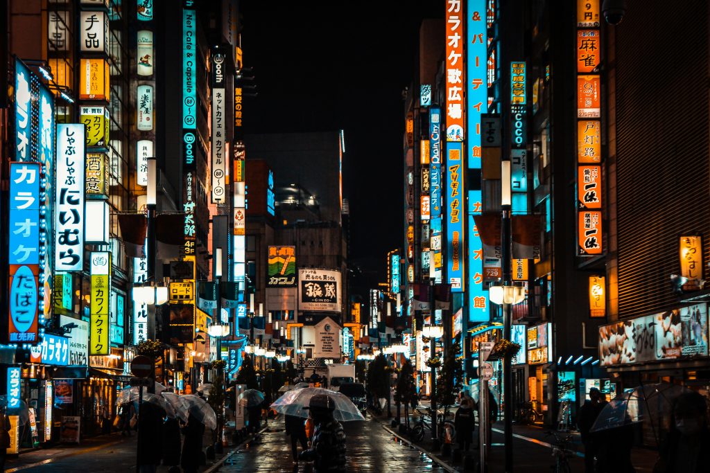 Tokyo city at night with bright neon lights, busy streets and skyline view